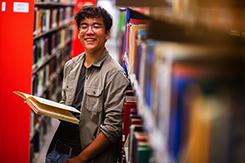 Student reads book in Woodward Library